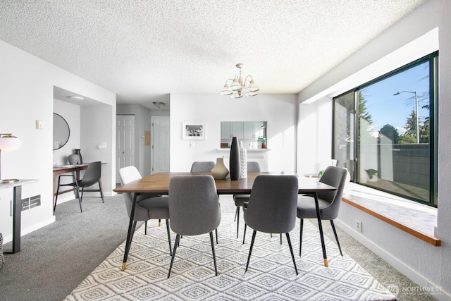 carpeted dining space featuring baseboards, visible vents, a textured ceiling, and an inviting chandelier