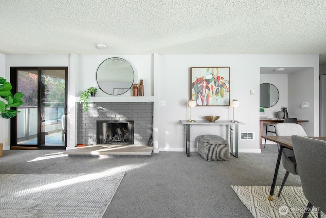 carpeted living room featuring visible vents, baseboards, a textured ceiling, and a brick fireplace