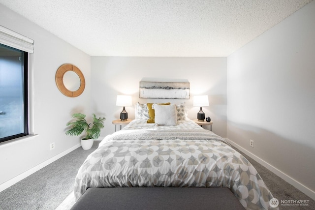 carpeted bedroom with a textured ceiling and baseboards