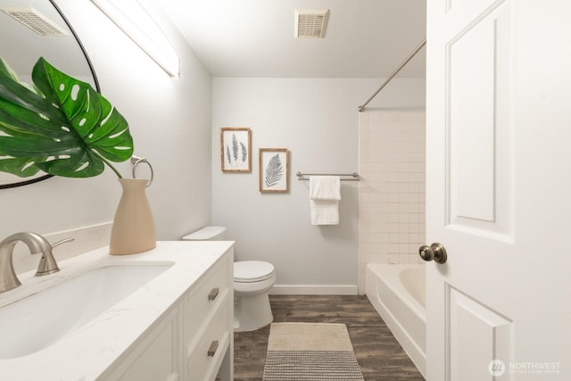 full bath with visible vents, toilet, wood finished floors, and vanity