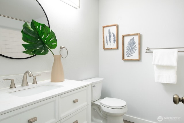 bathroom with toilet and vanity