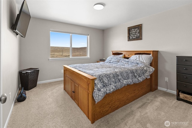 bedroom featuring baseboards and light carpet