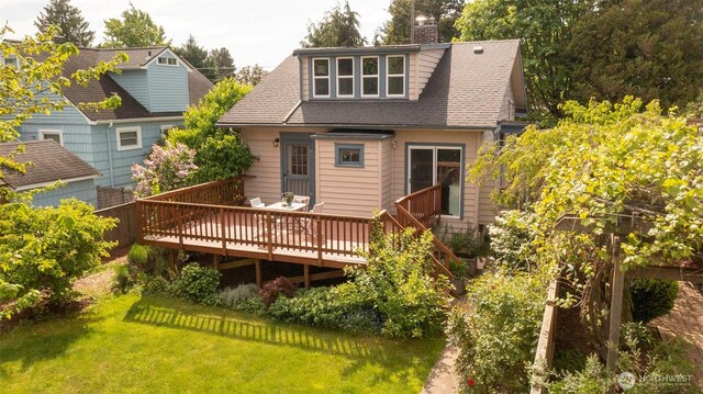 10538 Evanston Ave N, Seattle, WA 98133 - rear view of house featuring a wooden deck, a chimney, a lawn, and roof with shingles
