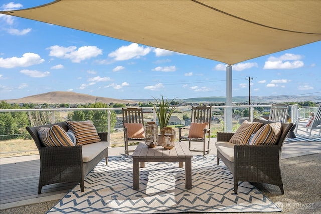 view of patio / terrace featuring a mountain view and a balcony