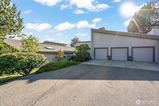view of home's exterior featuring an outdoor structure and a garage