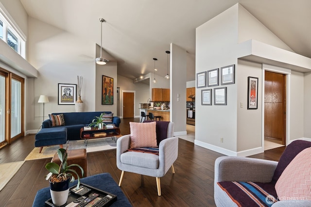 living room with dark wood-style floors, high vaulted ceiling, baseboards, and a ceiling fan