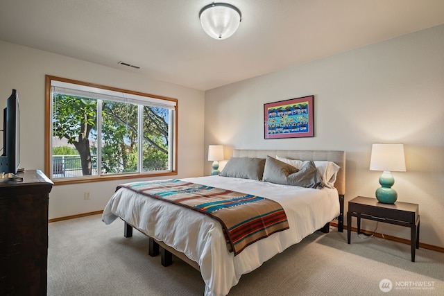 bedroom featuring baseboards, visible vents, and carpet floors