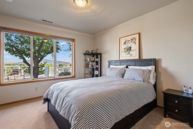 carpeted bedroom with crown molding, baseboards, and visible vents