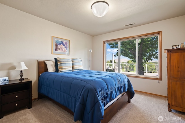 bedroom with visible vents, carpet floors, and baseboards