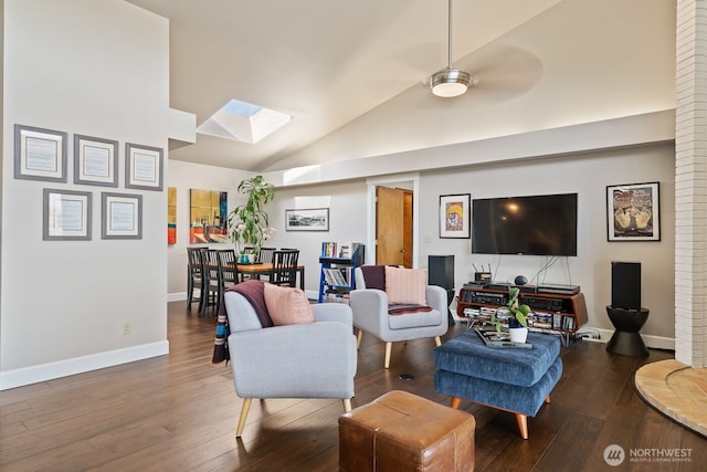 living room with baseboards, a skylight, a ceiling fan, and hardwood / wood-style flooring