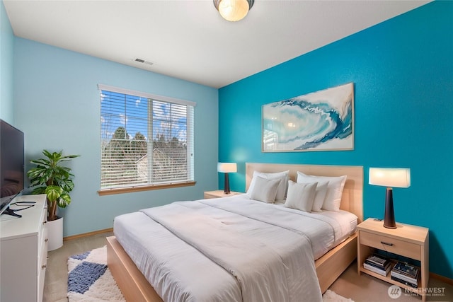 bedroom featuring visible vents and baseboards