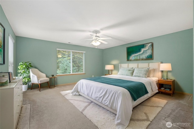 carpeted bedroom with baseboards and a ceiling fan