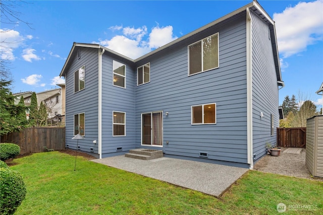 back of house featuring crawl space, a patio, a lawn, and a fenced backyard