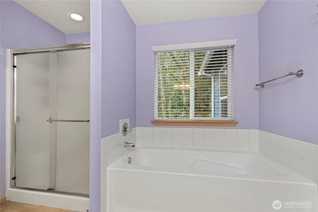 bathroom featuring recessed lighting, a bath, and a shower stall