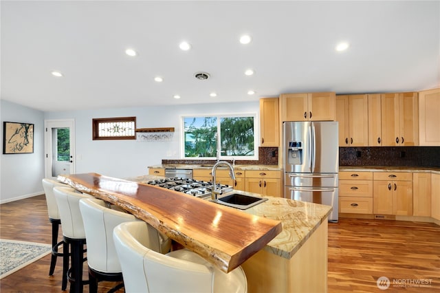 kitchen featuring visible vents, plenty of natural light, light brown cabinets, and stainless steel appliances