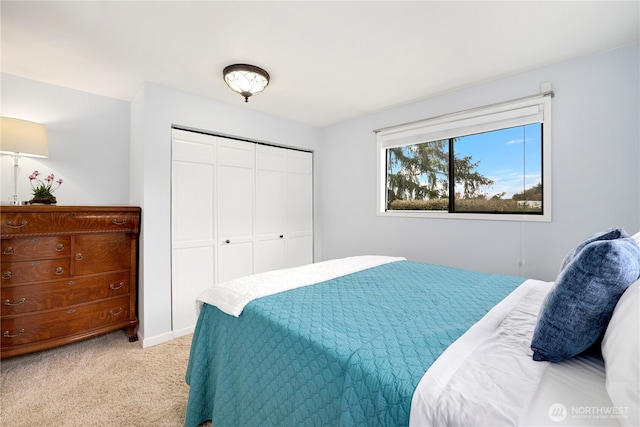 bedroom featuring light carpet and a closet