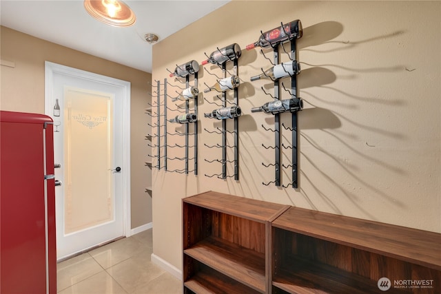 mudroom with light tile patterned floors and baseboards