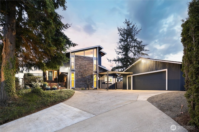 view of front of property featuring stone siding and a garage