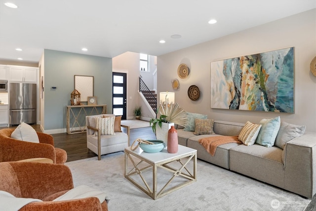 living area featuring stairway, recessed lighting, wood finished floors, and baseboards