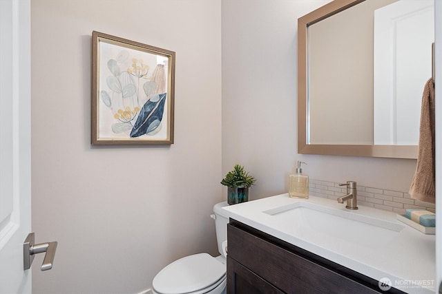 bathroom featuring toilet and vanity