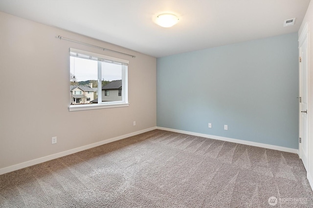 unfurnished room with visible vents, baseboards, and carpet flooring