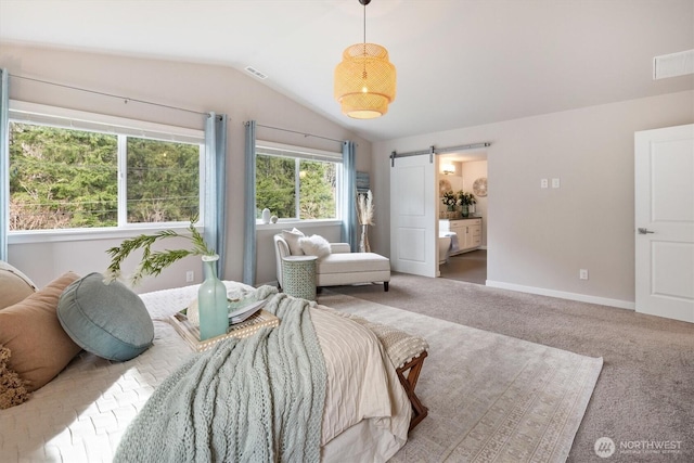 bedroom with baseboards, carpet floors, lofted ceiling, a barn door, and connected bathroom