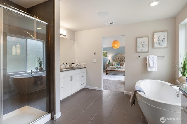 ensuite bathroom with vanity, visible vents, a soaking tub, a shower stall, and connected bathroom