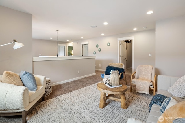 carpeted living area featuring recessed lighting and baseboards