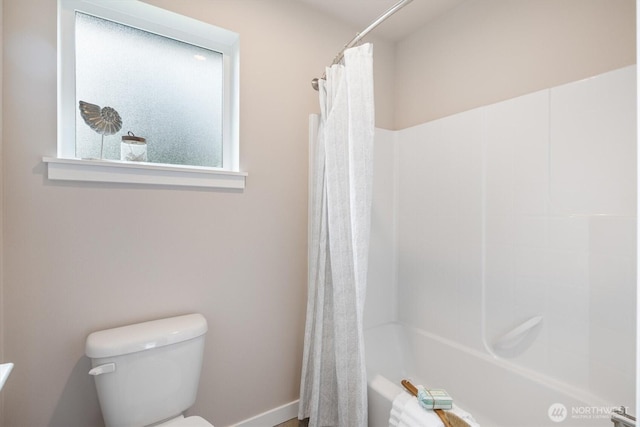 bathroom with toilet and shower / tub combo with curtain