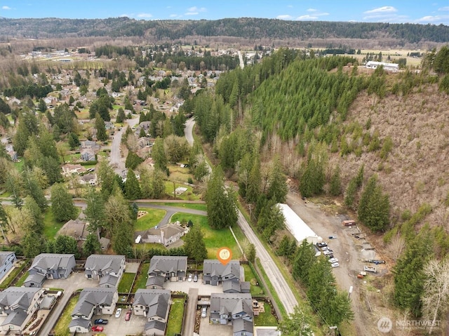 birds eye view of property with a view of trees