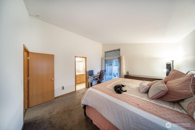 carpeted bedroom with vaulted ceiling, baseboards, and connected bathroom