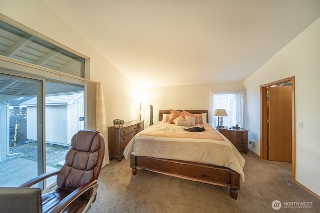 bedroom with lofted ceiling, access to exterior, and carpet flooring