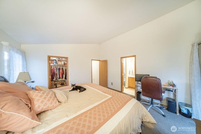 carpeted bedroom featuring ensuite bath and lofted ceiling