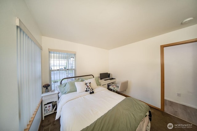 bedroom featuring baseboards and carpet floors