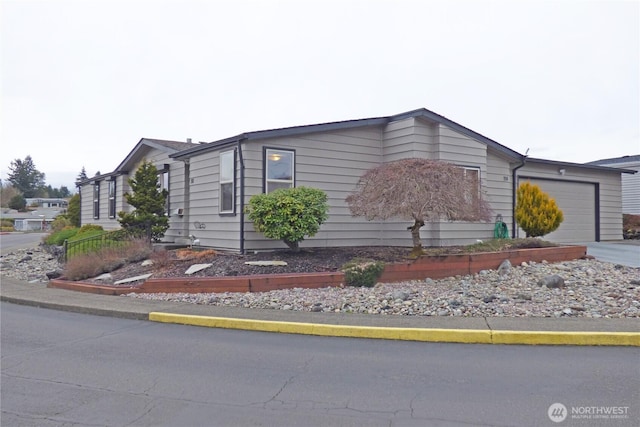 view of front facade featuring concrete driveway and an attached garage