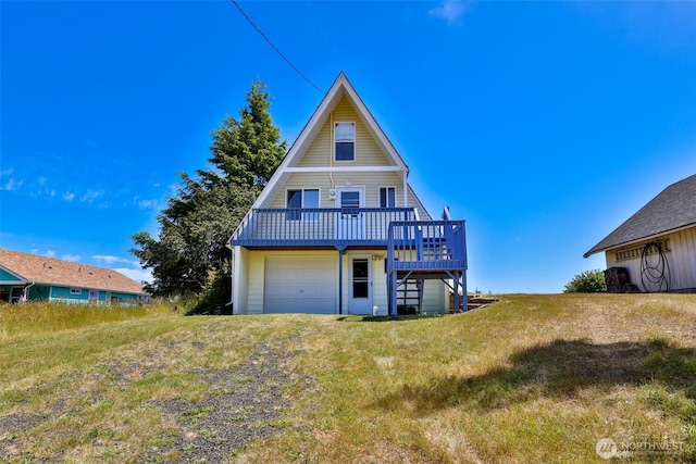 662 Mt Olympus Ave SE, Ocean Shores, WA 98569 - rear view of property featuring a wooden deck, an attached garage, and a lawn