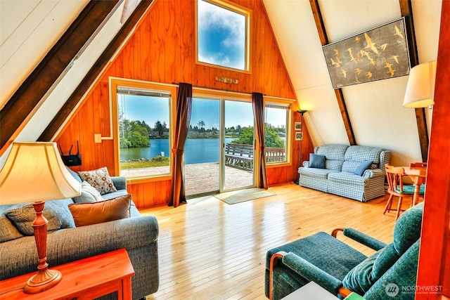 662 Mt Olympus Ave SE, Ocean Shores, WA 98569 - living area with wood walls, hardwood / wood-style flooring, and a water view