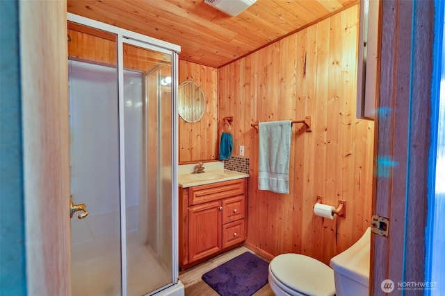 662 Mt Olympus Ave SE, Ocean Shores, WA 98569 - full bathroom featuring a stall shower, vanity, toilet, wooden walls, and wood ceiling