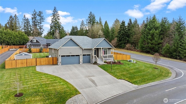 view of front of home featuring a front lawn, an attached garage, fence, and driveway