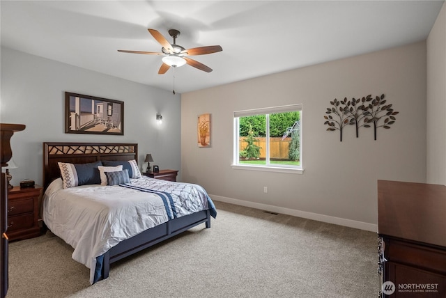 carpeted bedroom featuring baseboards and ceiling fan