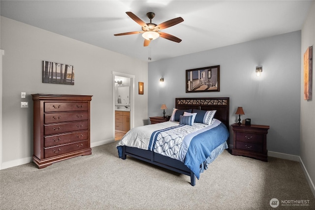 carpeted bedroom featuring a ceiling fan, baseboards, and connected bathroom