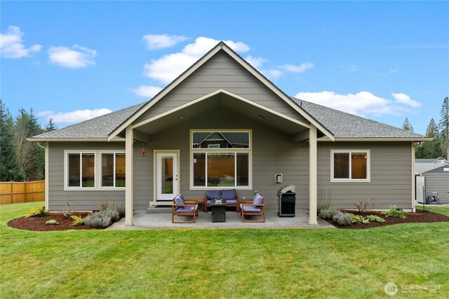 back of property with a patio area, a yard, and fence