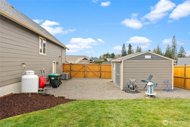 view of yard with a patio, a gate, fence, a shed, and an outdoor structure