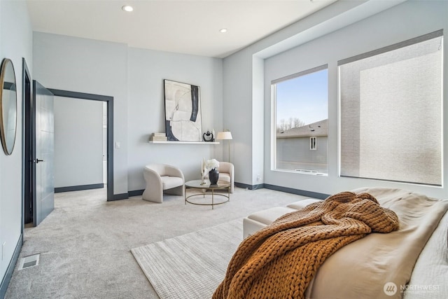 living area with visible vents, recessed lighting, baseboards, and carpet