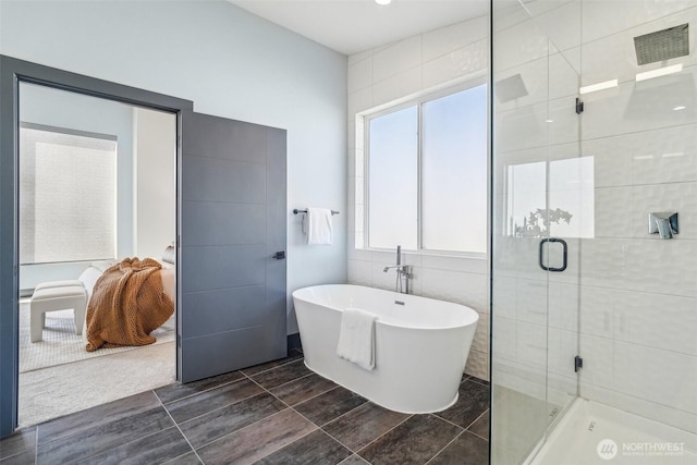 full bathroom featuring a shower stall and a soaking tub