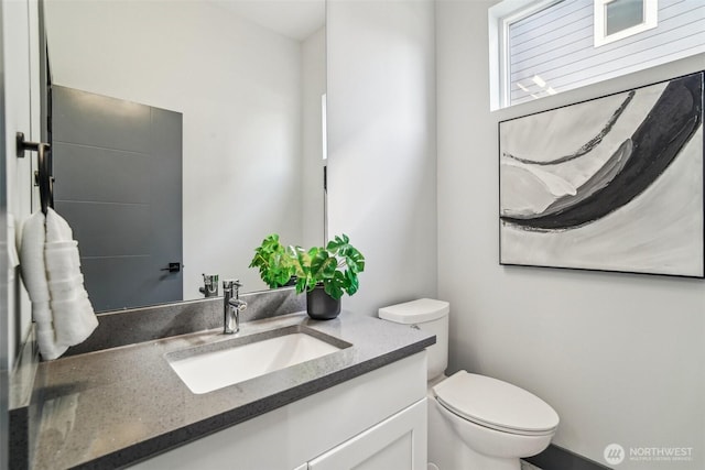 bathroom featuring toilet and vanity