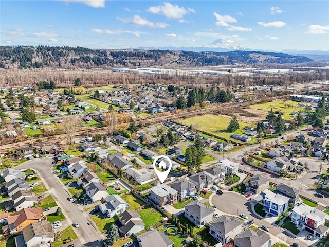 birds eye view of property with a mountain view and a residential view