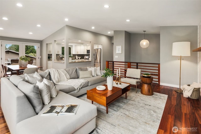 living area with vaulted ceiling, recessed lighting, baseboards, and wood finished floors