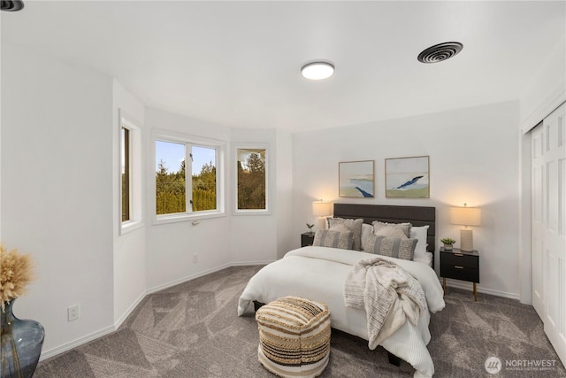 carpeted bedroom featuring a closet, visible vents, and baseboards