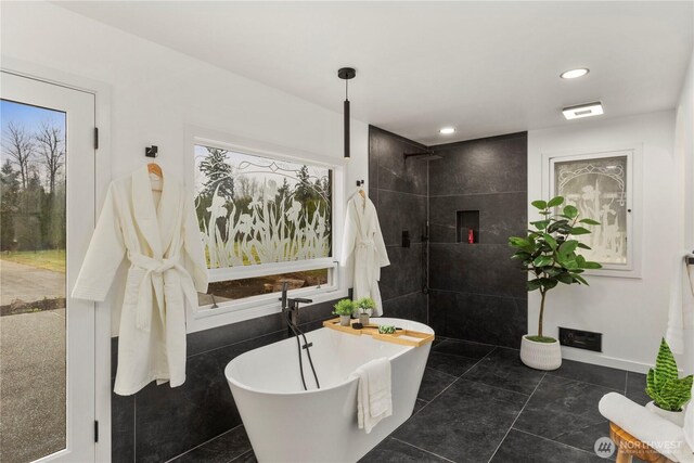 bathroom with tile patterned flooring, recessed lighting, a freestanding bath, and walk in shower